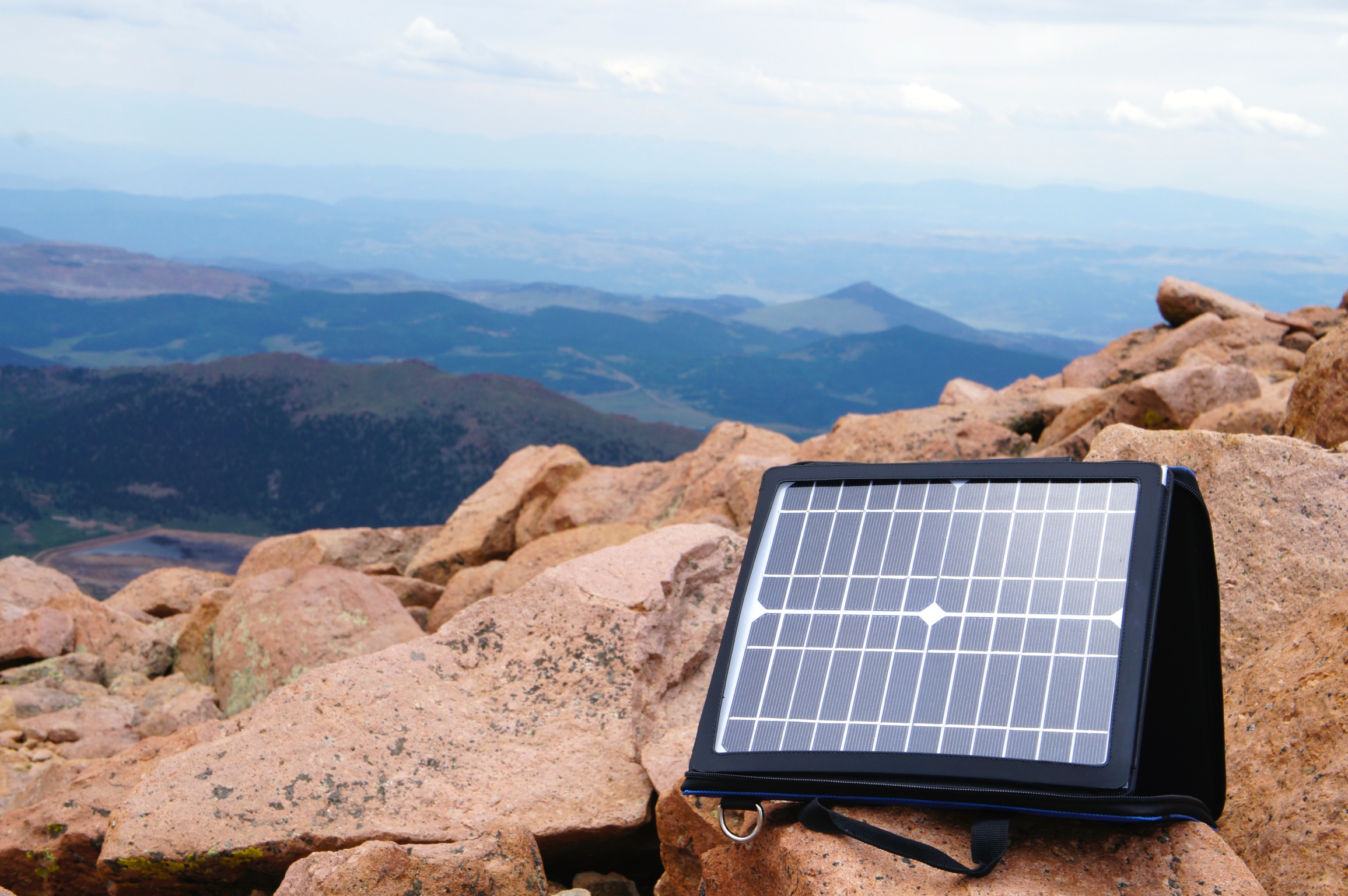 SunVolt solar charger set up outdoors on rocks